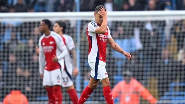 Leandro Trossard of Arsenal leaves the pitch after being shown a red card during the Premier League match between Manchester City FC and Arsenal FC at Etihad Stadium on September 22, 2024 in Manchester, England