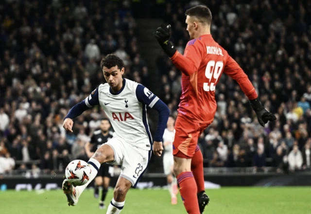 Qarabag's Mateusz Kochalski in action with Tottenham Hotspur's Brennan Johnson