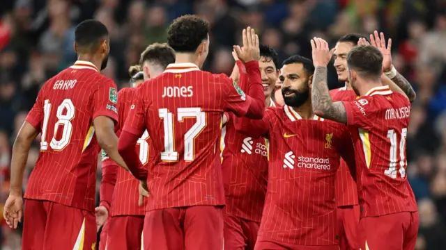 Mohamed Salah of Liverpool celebrates scoring his team's third goal with teammate Curtis Jones during the Carabao Cup Third Round match between Liverpool and West Ham United at Anfield on September 25, 2024 in Liverpool, England.