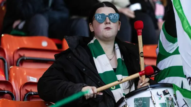 Celtic fan banging a drum