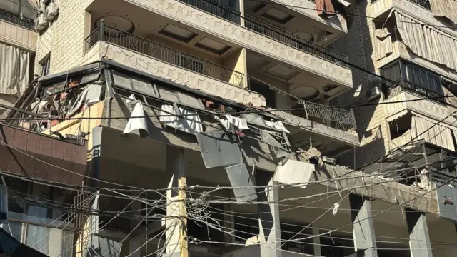 A close-up of damage to an apartment building