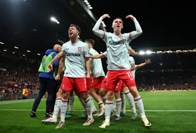 Twente celebrate after scoring against Manchester United