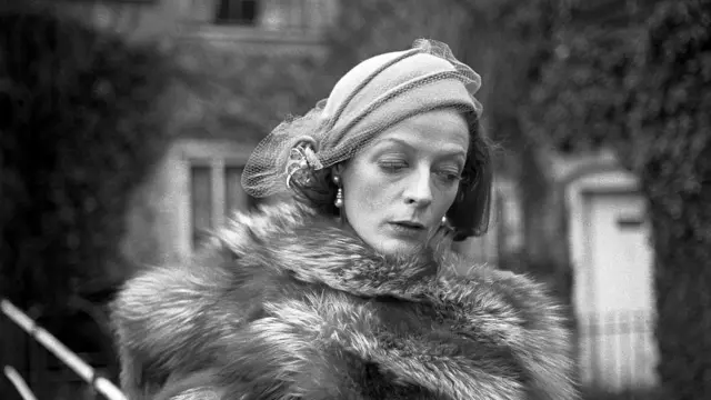 Dame Maggie Smith wearing a fur jacket