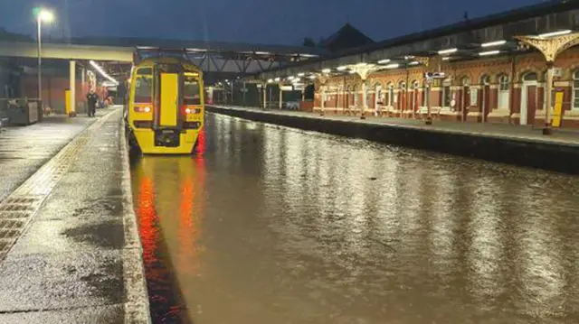 A train stands stranded at Wellington Station in Shropshire after flooding submerged the tracks