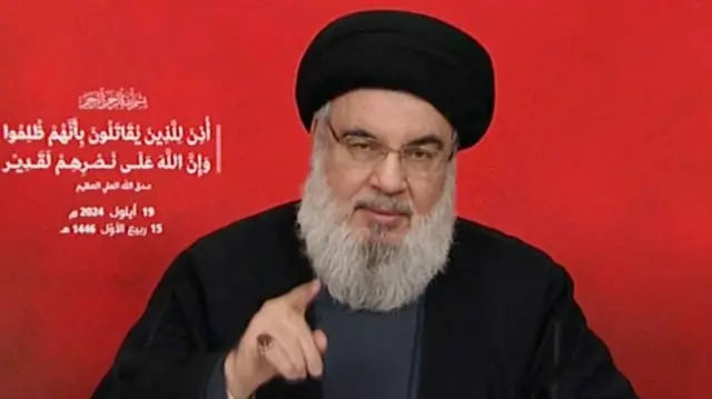 Hassan Nasrallah speaking into a camera during a televised address