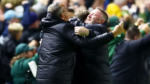 Plymouth manager Wayne Rooney celebrates with his coaching staff