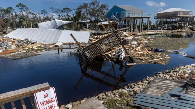 Debris from parts of a home sit in Florida after Helene tore through the area