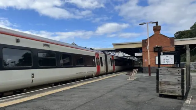 A white and red train carriage at Wellington railway station