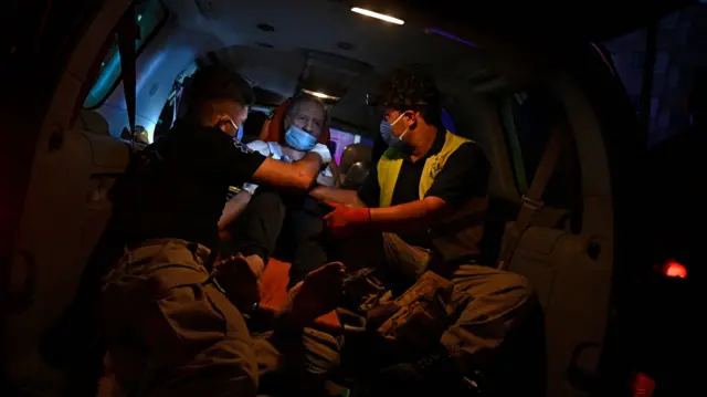 Ambulance workers help those injured in the attack