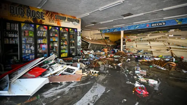 Debris floats in a flooded store in Cedar Key