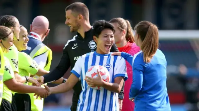 Seike reacts to be handed the match ball for her hat-trick