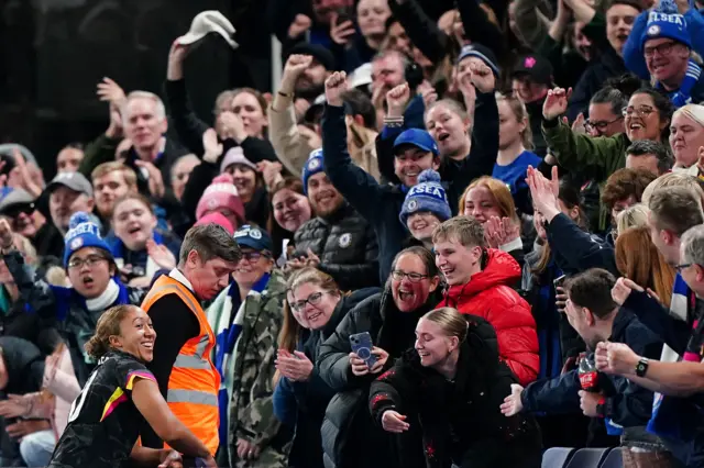 James celebrates with the travelling Chelsea fans