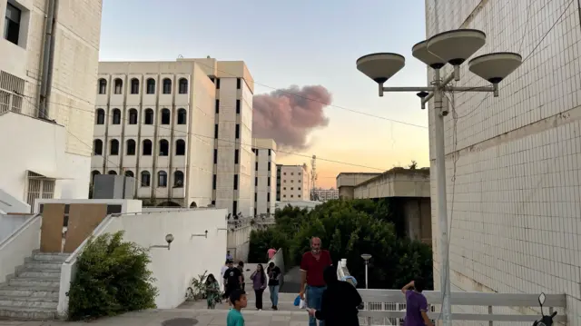 The early moments of the air strike, a smoke cloud can be seen rising over a school building