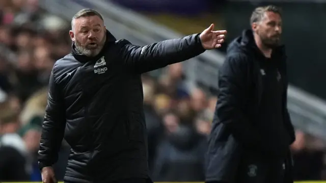 Wayne Rooney and Rob Edwards on the touchline at Home Park.