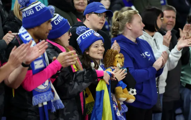 Chelsea fans cheer and smile in the fans