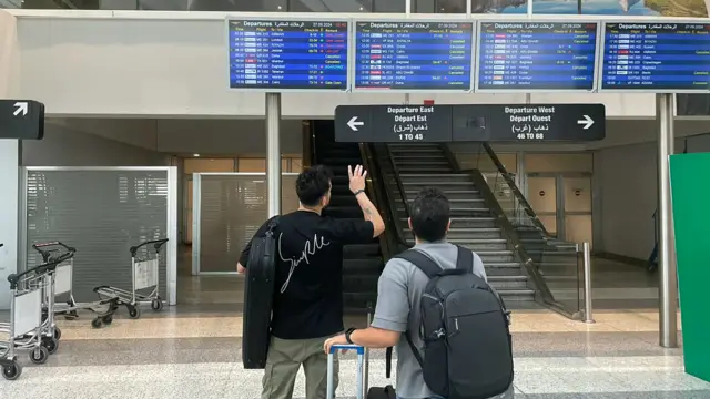 This picture shows passengers checking the departures board at Beirut International airport on September 27, 2024, amid cross-border clashes with the Lebanese group Hezbollah and Israel. Israel and Hezbollah traded fire on September 27 after the United States and its allies failed to secure a halt in clashes that have killed more than 700 people in Lebanon this week.