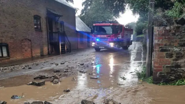 A fire engine in flood water in All Stretton