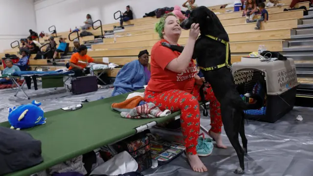 Amber Hardin, 27, spends time with her dog Ducky while taking shelter from Hurricane Helene