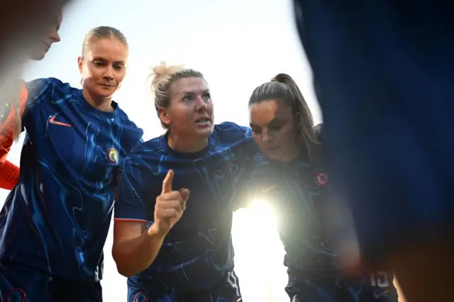 Mille Bright speaking to her teammates in a huddle