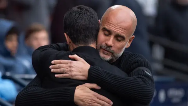 Pep Guardiola and Mikel Arteta embrace
