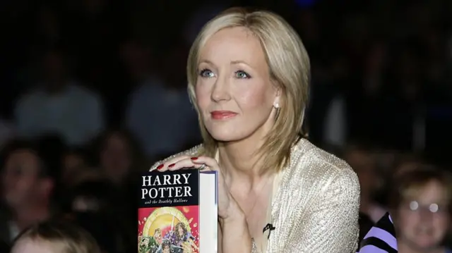 JK Rowling holds a copy of the final Harry Potter book