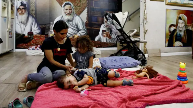 An Israeli family sleeps in a bomb shelter in northern Israel