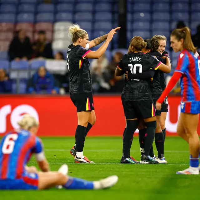 Chelsea players celebrate one of their seven goals as Palace players stand deflated