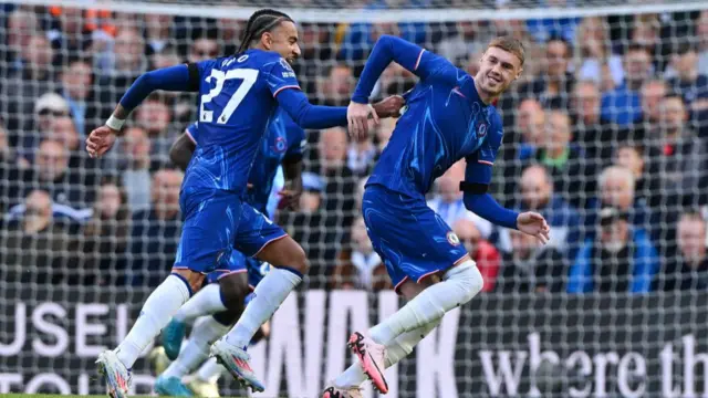 ole Palmer of Chelsea celebrates scoring his team's third goal and his hat trick with team mate Malo Gusto during the Premier League match between Chelsea FC and Brighton & Hove Albion FC at Stamford Bridge on September 28, 2024 in London, England.