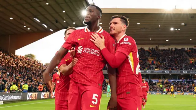 brahima Konate of Liverpool celebrates scoring the first goal with Andrew Robertson during the Premier League match between Wolverhampton Wanderers FC and Liverpool FC at Molineux on September 28, 2024 in Wolverhampton, England.