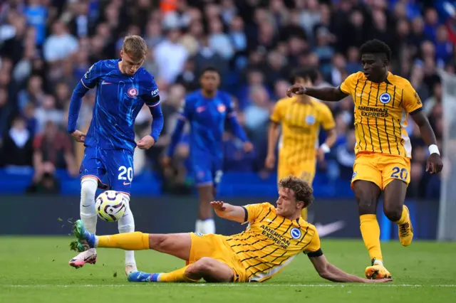 Cole Palmer (left) and Brighton and Hove Albion's Mats Wieffer battle for the ball