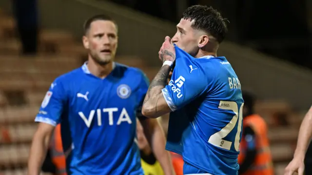 Louie Barry kisses the Stockport badge on his shirt after scoring against Barnsley