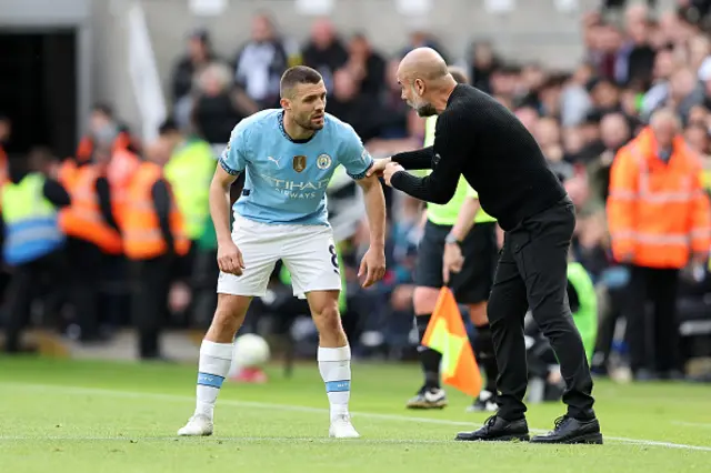 Josep Guardiola, Manager of Manchester City, gives instructions to Mateo Kovacic