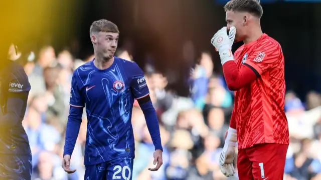 Cole Palmer of Chelsea exchanges words with Bart Verbruggen of Brighton & Hove Albion after he scores from the spot to make it 2-1 during the Premier League match between Chelsea FC and Brighton & Hove Albion FC at Stamford Bridge on September 28, 2024 in London, England.