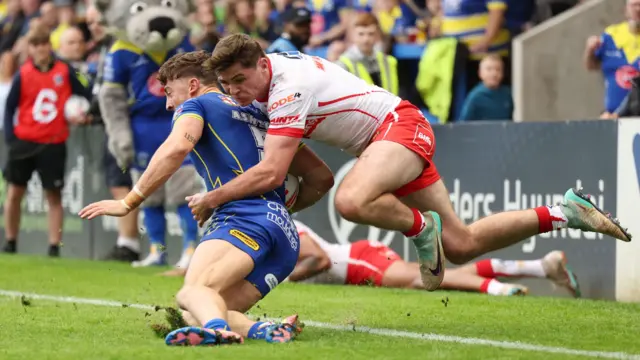 Warrington Wolves' Matty Ashton is tackled by St Helens' Jack Welsby