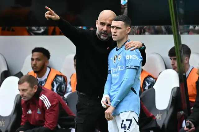 Pep Guardiola (L) speaks with Manchester City's English midfielder #47 Phil Foden