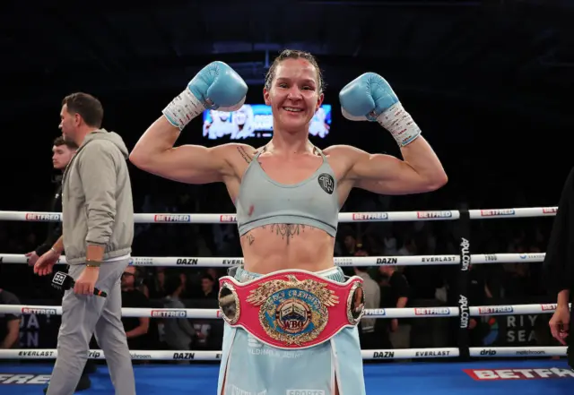 Terri Harper posing with her world title around her waist