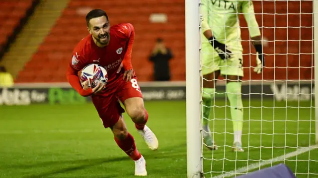 Barnsley's Adam Phillips grabs the ball after converting his penalty against Stockport