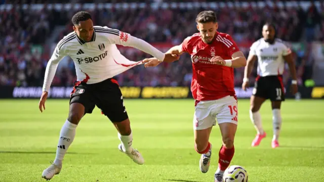 Alex Moreno of Nottingham Forest controls the ball under pressure from Kenny Tete of Fulham during the Premier League match between Nottingham Forest FC and Fulham FC at City Ground on September 28, 2024 in Nottingham, England.