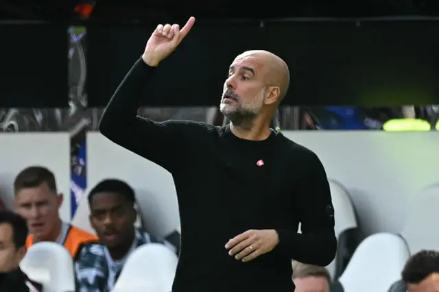 Pep Guardiola gestures on the touchline