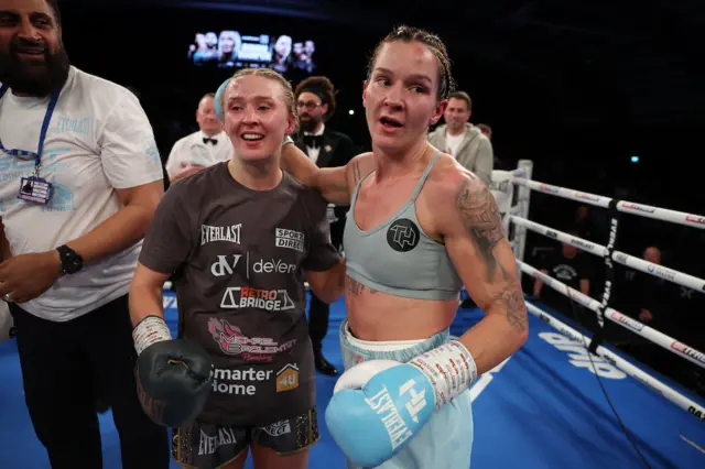 Rhiannon Dixon smiles with Terri Harper in the ring