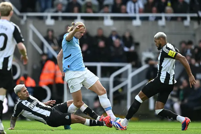 Erling Haaland (C) is tackled by Newcastle United's Brazilian midfielder Bruno Guimaraes