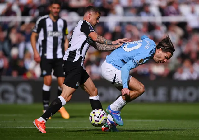 Jack Grealish of Manchester City is challenged by Kieran Trippier