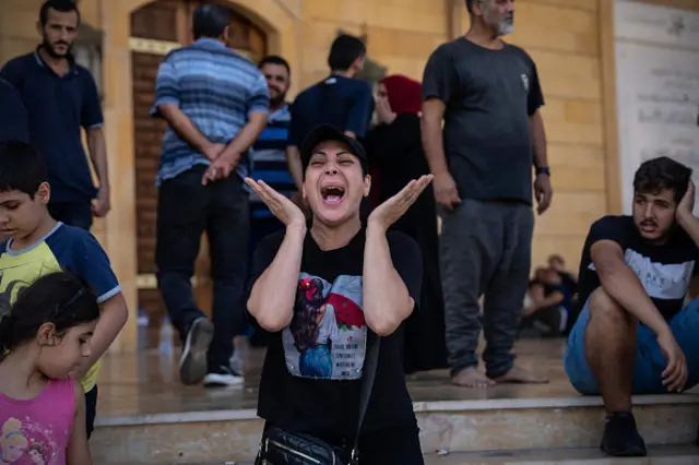 A woman screams in response to Nasrallah's death