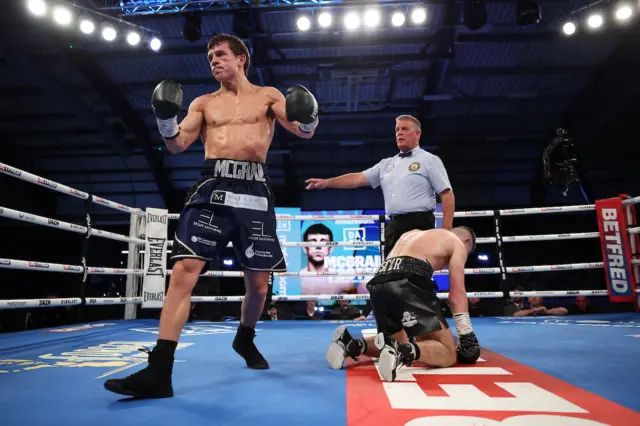 Peter McGrail stands over his floored opponent