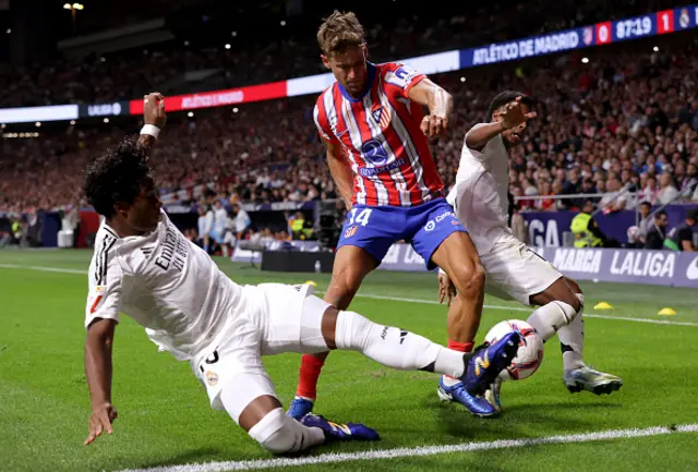 Marcos Llorente of Atletico de Madrid is challenged by Endrick and Rodrygo