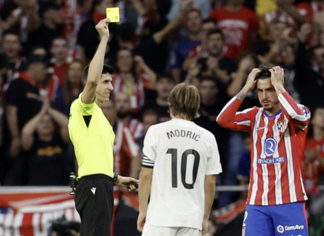 Luka Modric is shown a yellow card