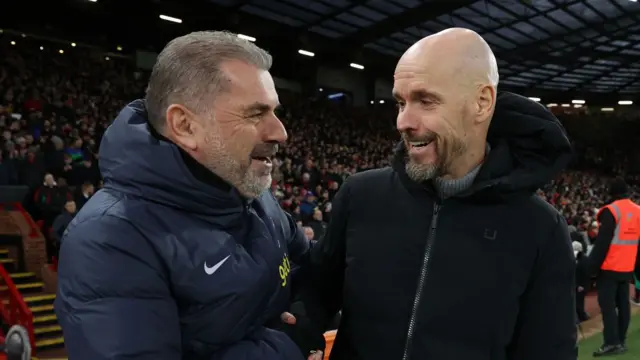 Manager Erik ten Hag of Manchester United greets manager Ange Postecoglou of Tottenham Hotspur ahead of the Premier League match between Manchester United and Tottenham Hotspur at Old Trafford on January 14, 2024 in Manchester, England.