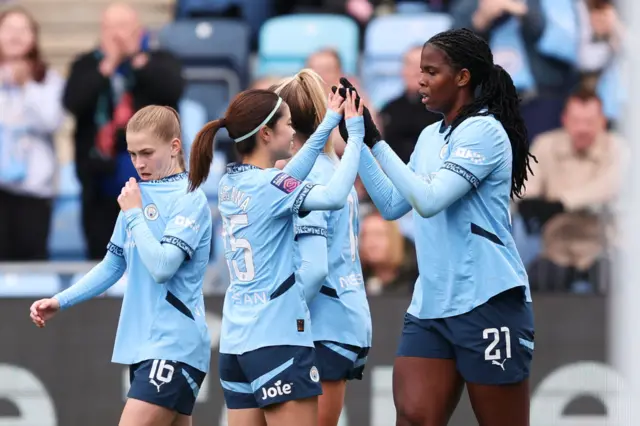 Khadija Shaw of Manchester City celebrates scoring her team's first goal with Yui Hasegawa