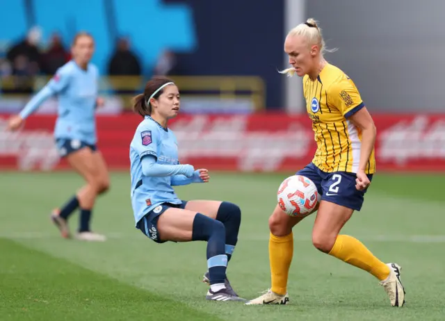 Maria Thorisdottir of Brighton & Hove Albion controls the ball under pressure from Yui Hasegawa