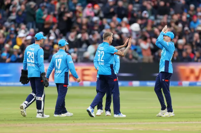 Brydon Carse celebrates the wicket of Travis Head